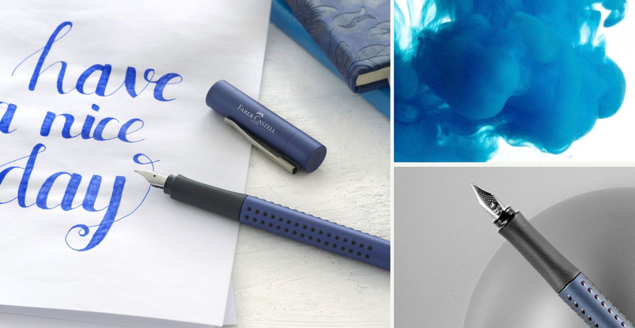 Matt blue grip fountain pen lying on a piece of paper on which "have a nice day" is written in blue.